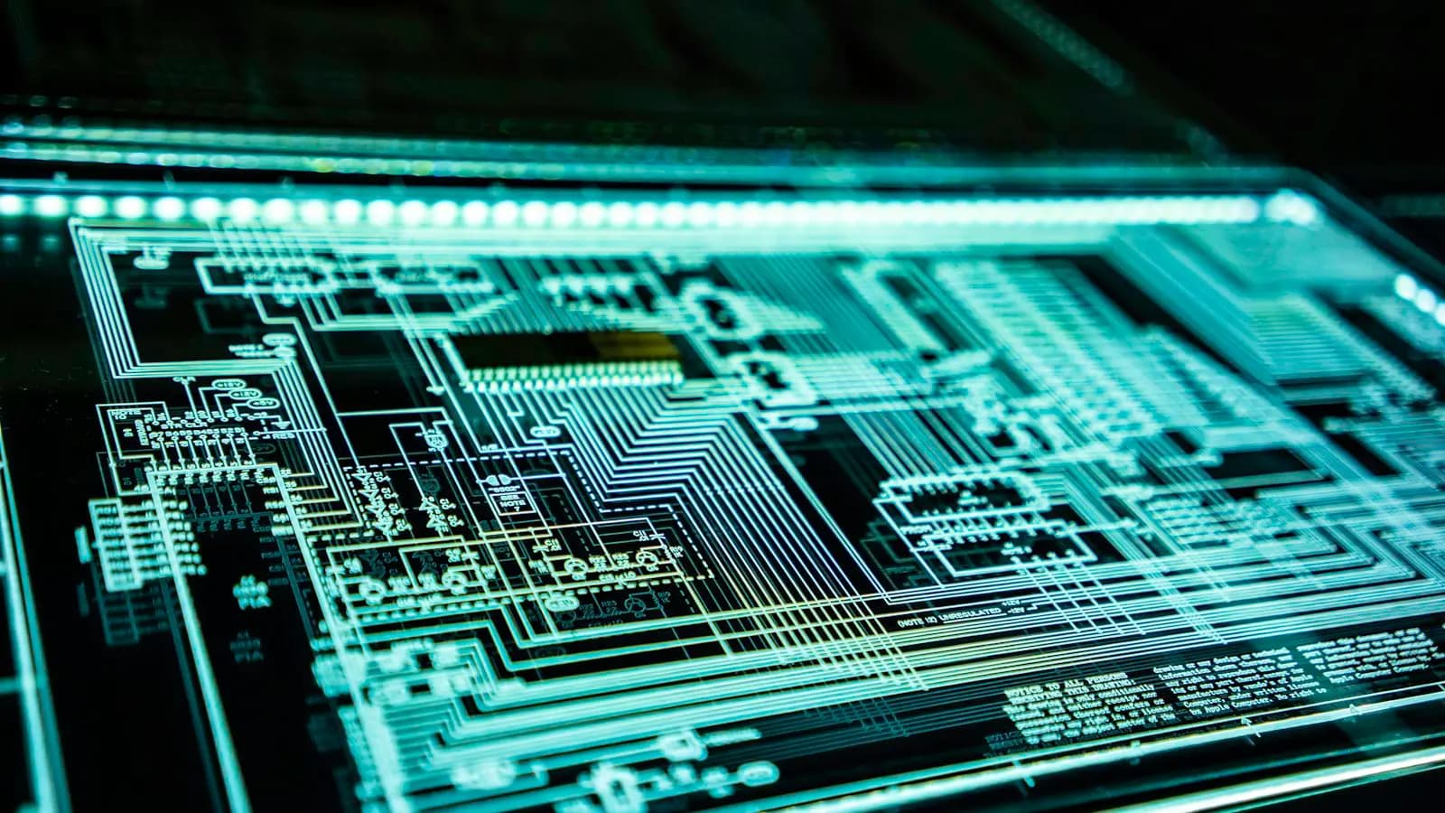 Glowing teal circuit-board schematic on a dark background