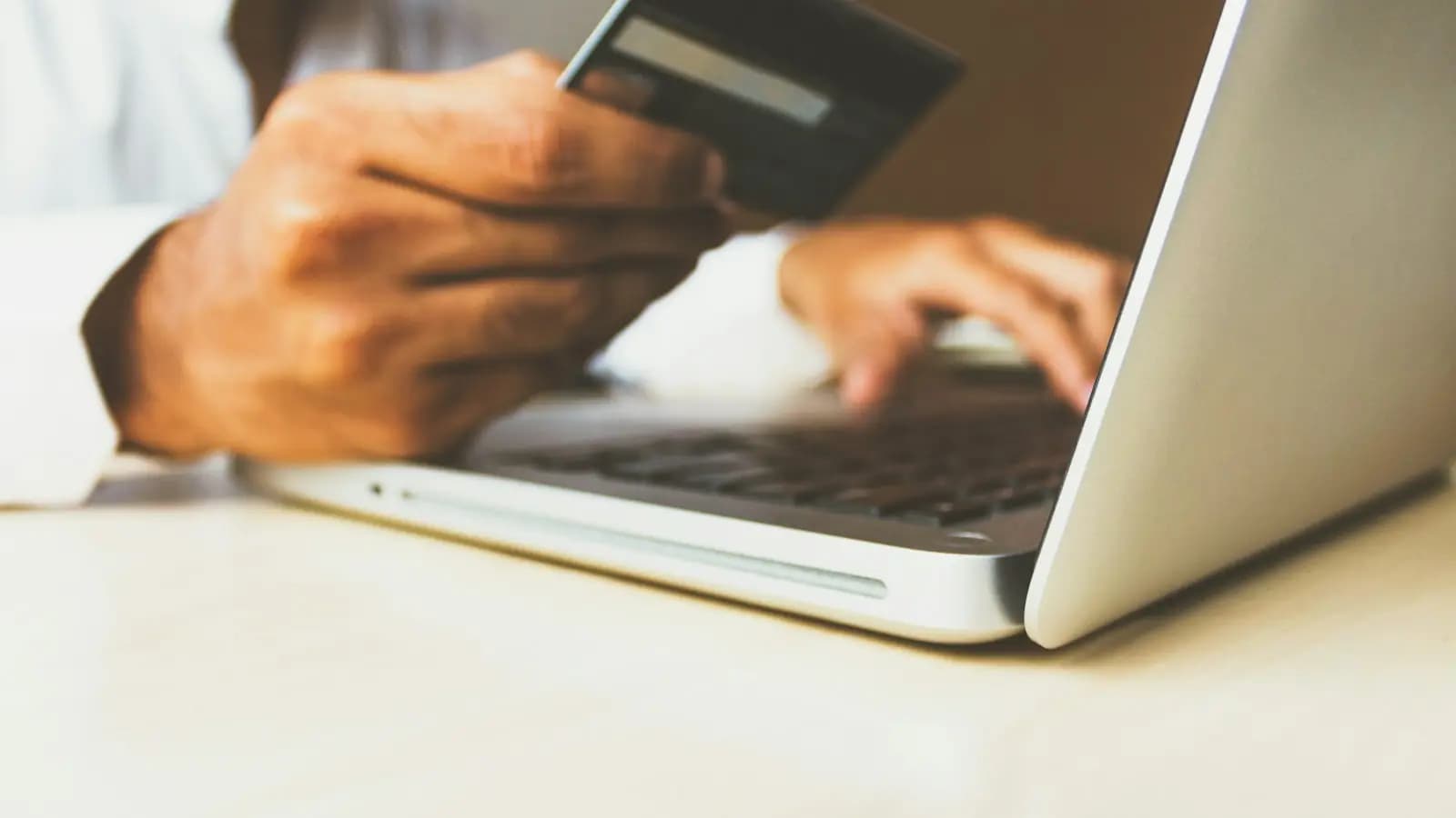 Shopper entering credit card details on a laptop