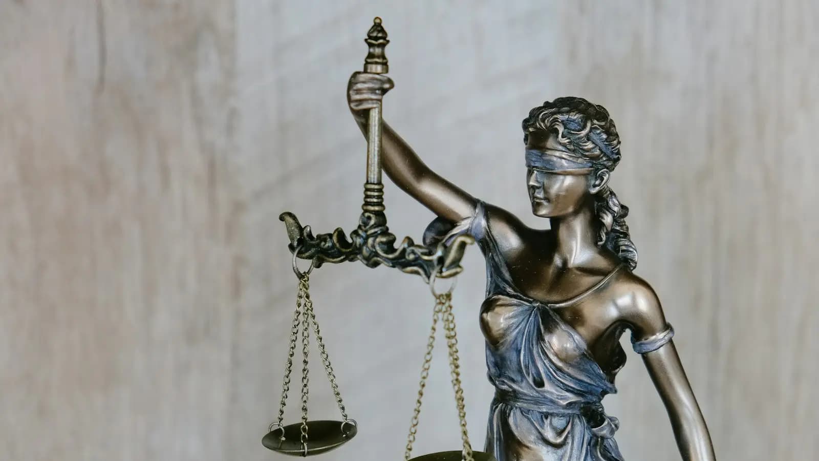 Statue of Lady Justice holding balanced scales