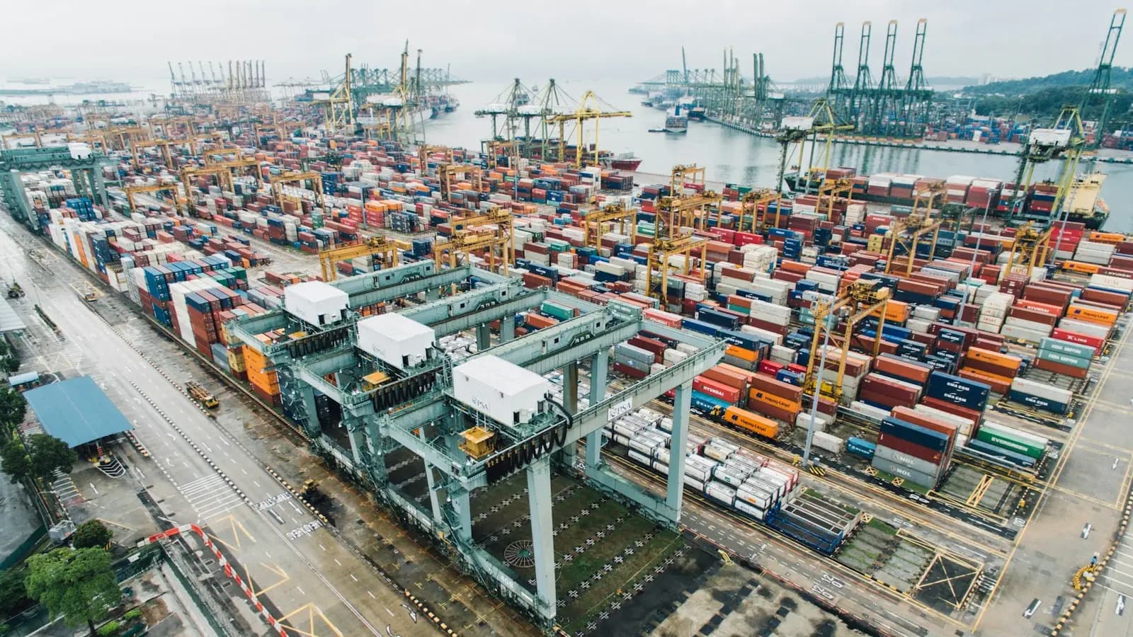 Aerial view of a container port with cranes and stacked containers