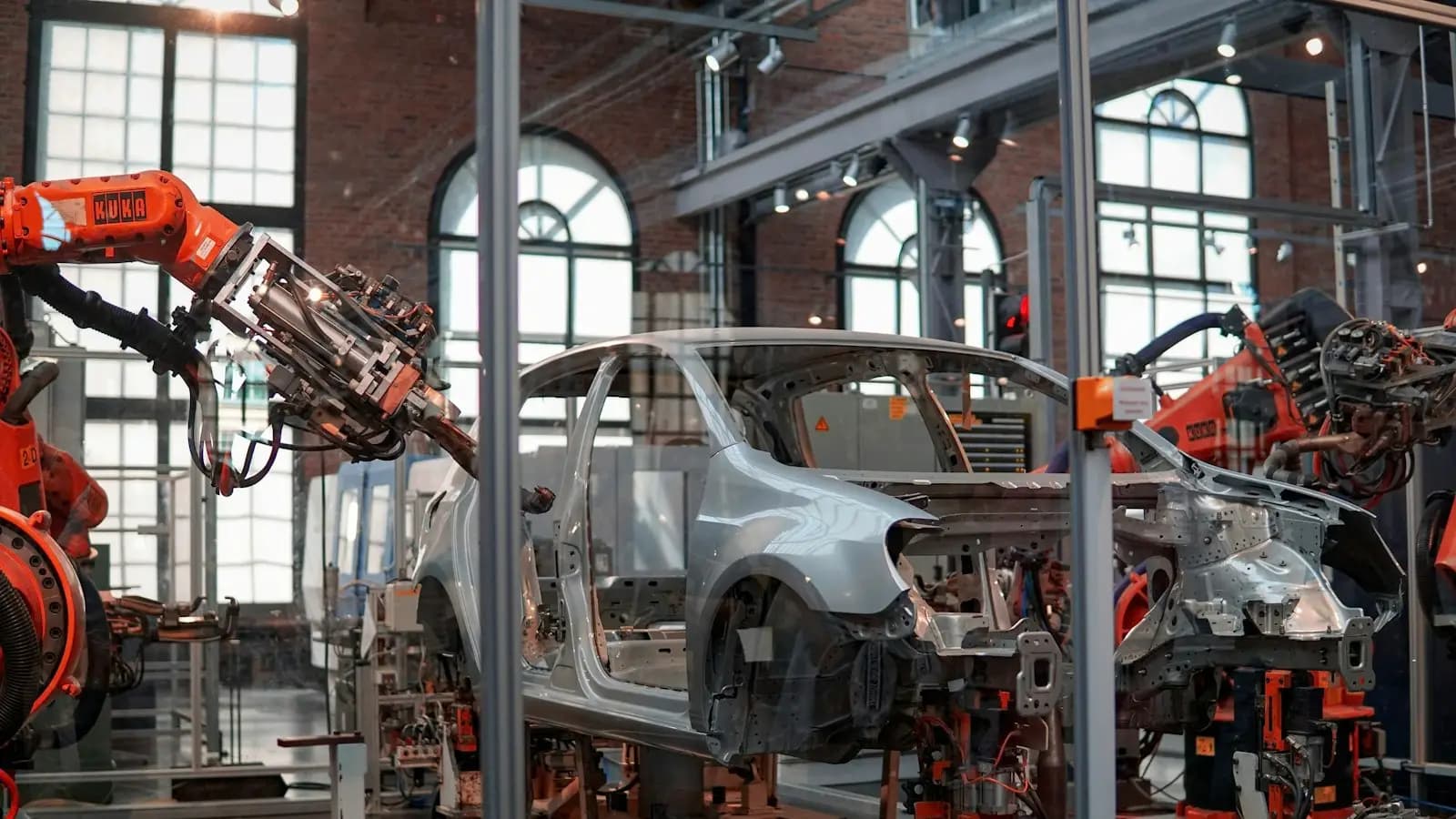 Robotic arms assembling a car body on a factory line