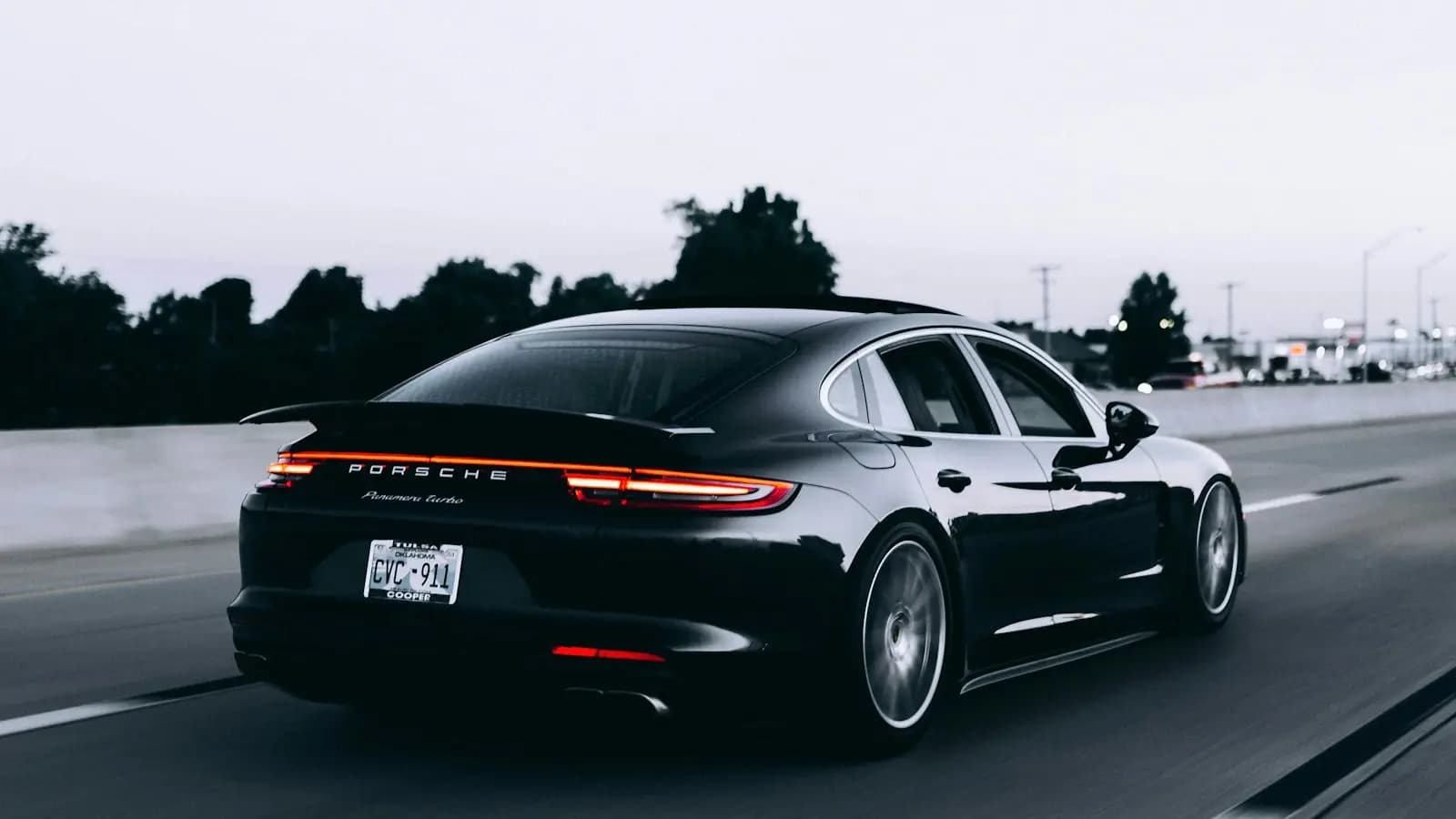 Black sports car driving on an open road